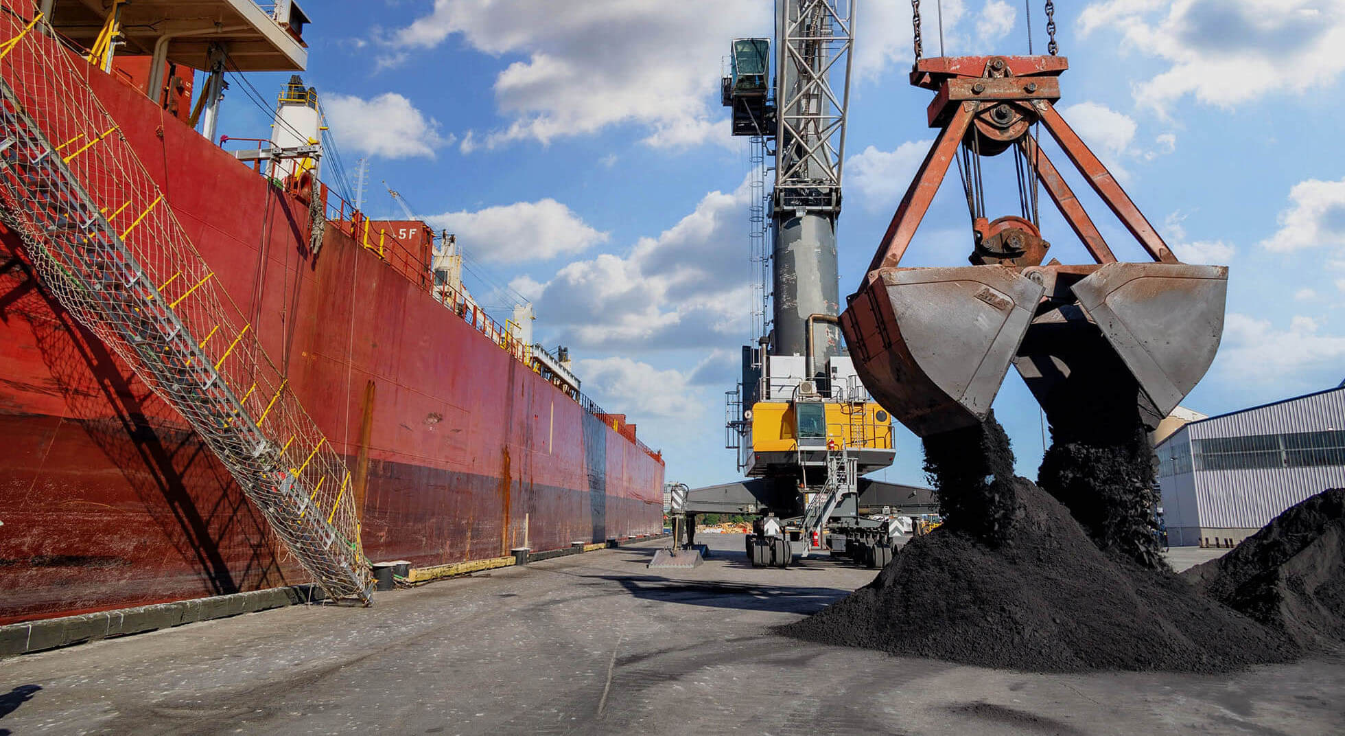 liebherr crane offloading bulk material from ship at the port