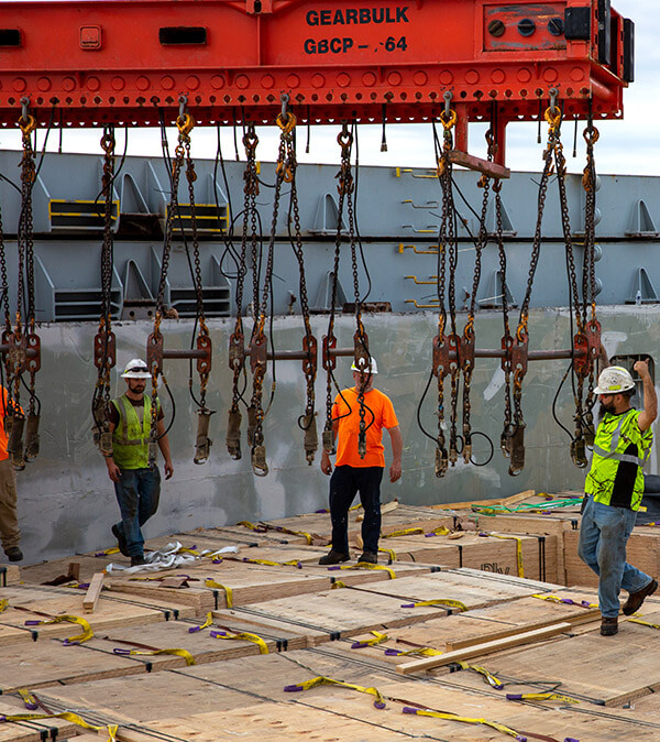 stevedores on ship unloading dimensional lumber