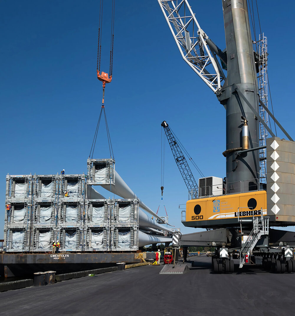 liebherr crane lifting wind turbine rotars from a barge