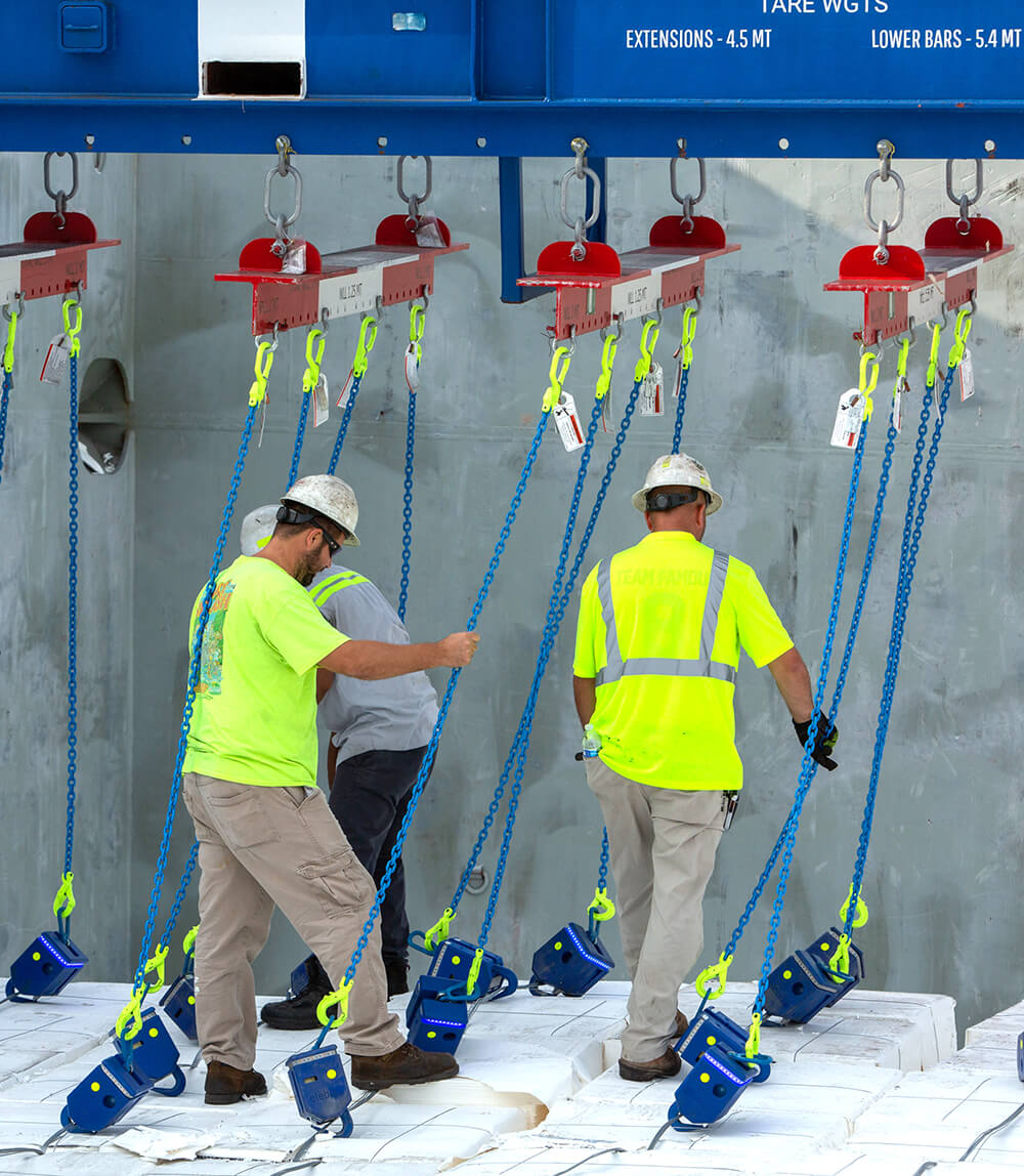stevedores securing break bulk cargo inside a ship's hold
